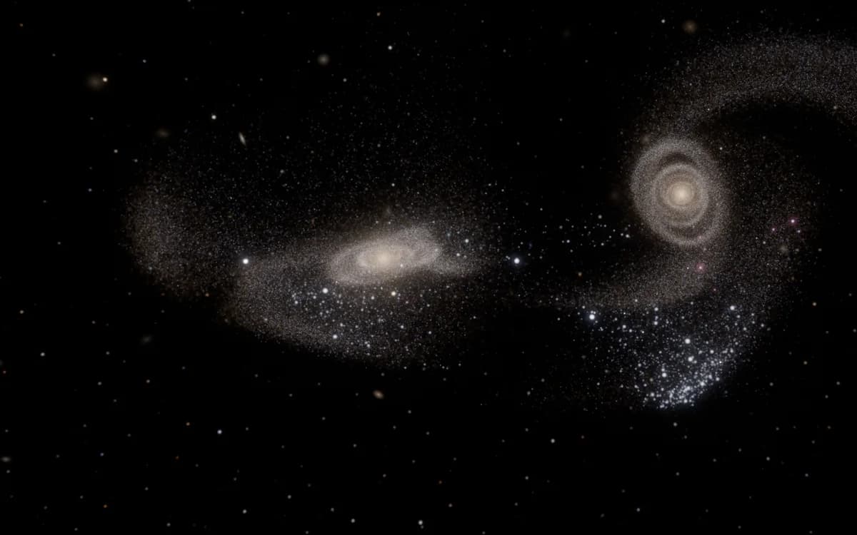 Two spiral galaxies after first passage, throwing out long tidal tails and blue star clusters